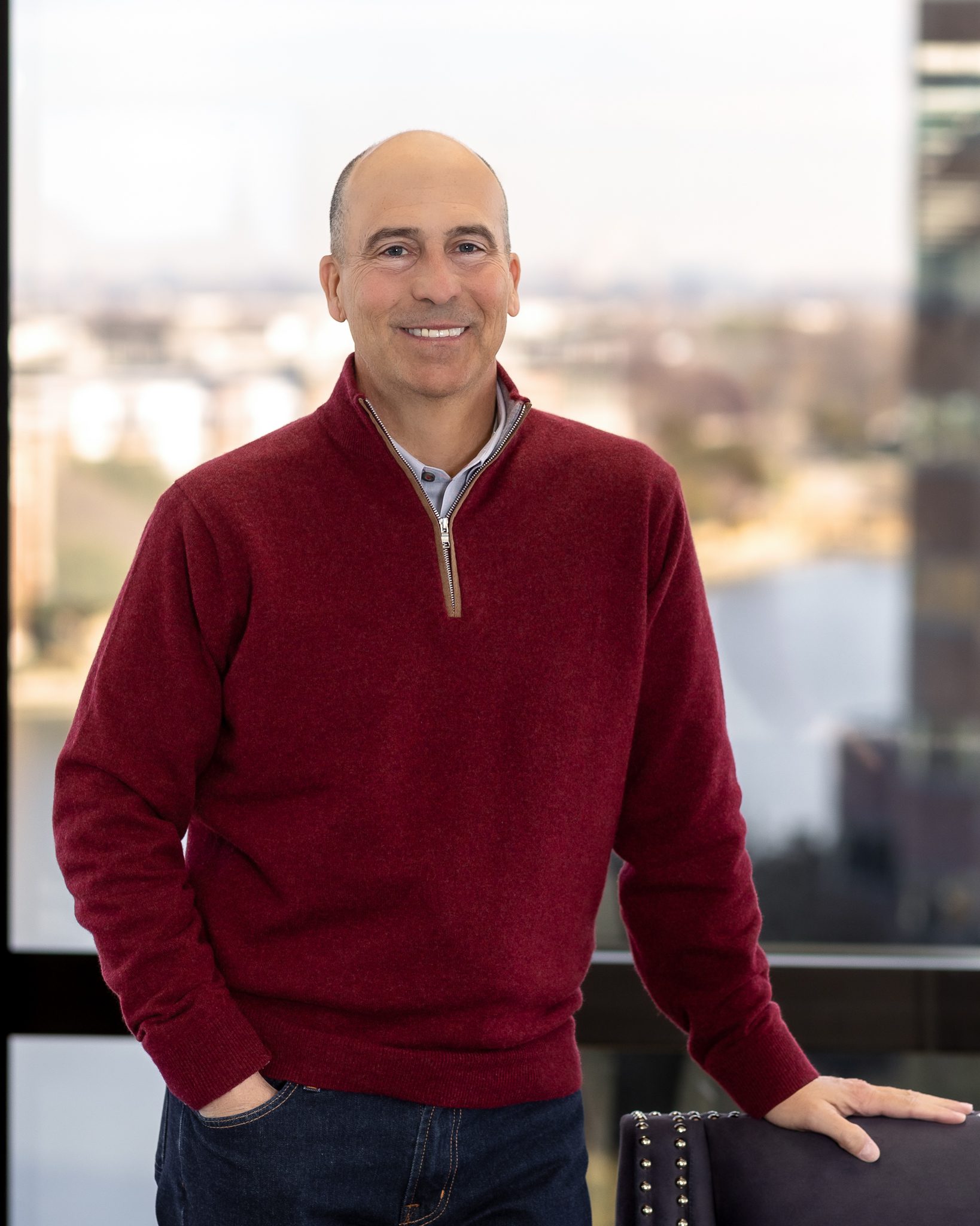 Scott A man in a red sweater standing with his hands on his hips.