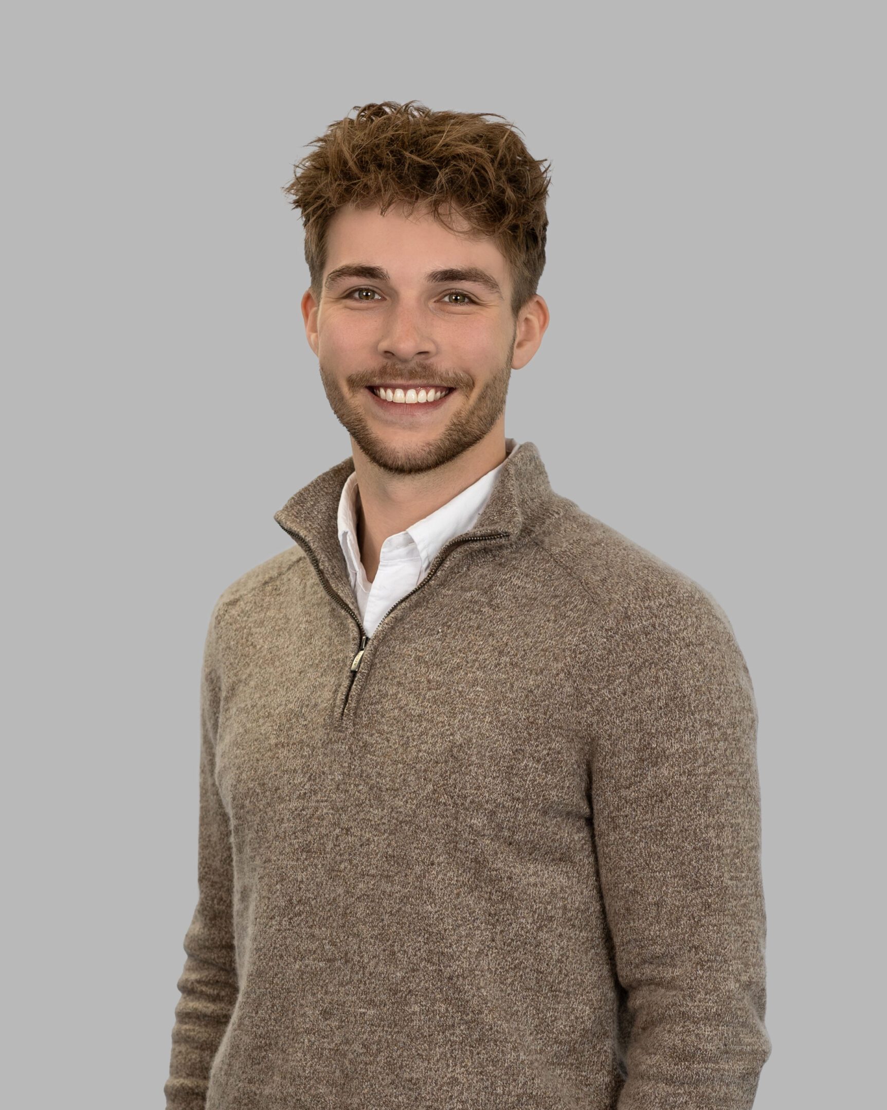 Bailey_Hester-110-Print A man in brown sweater standing next to wall.