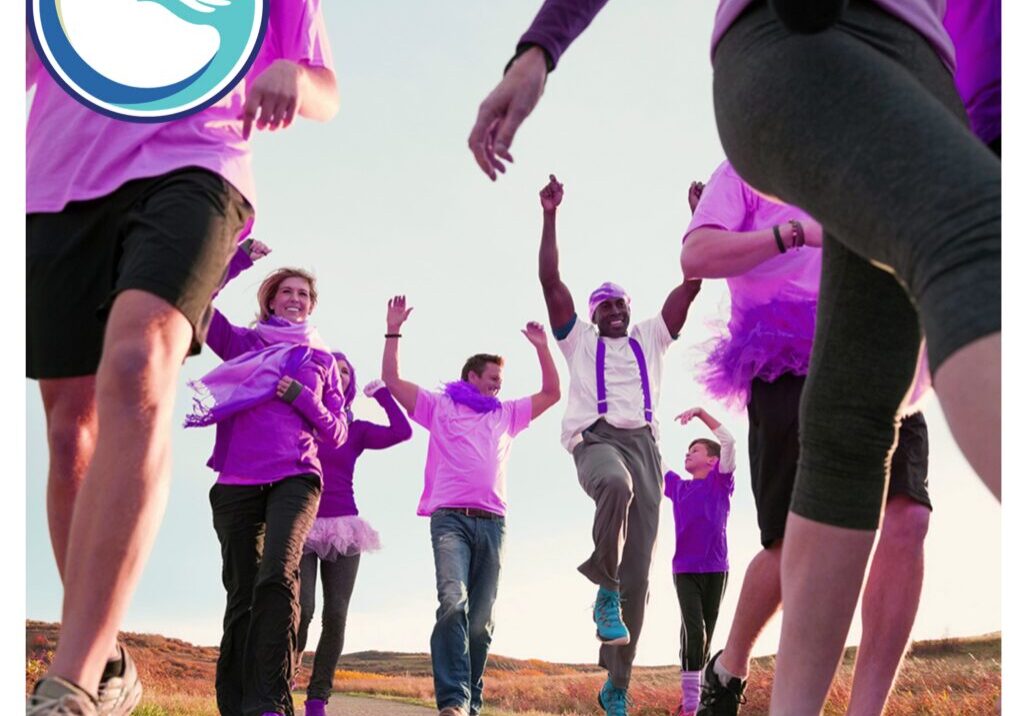 Best Buddies Walks A group of people in purple shirts and black shorts.